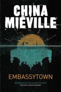Cover of Embassytown with a mirrored gold and turquoise abstract city structure against a black background